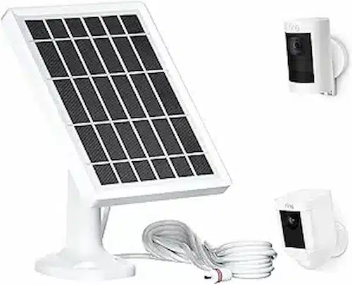 Ring Stick Up Cam Solar placed in a backyard with a solar panel attached.